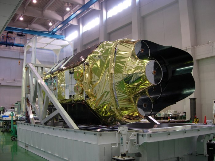 Astro-E2 lies on its side, with the five mirrors pointing toward us. (84K JPEG)