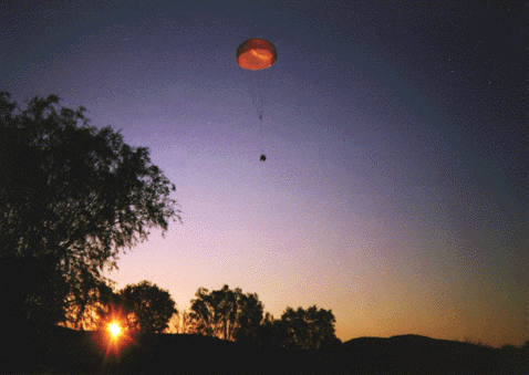 payload descending at sunset