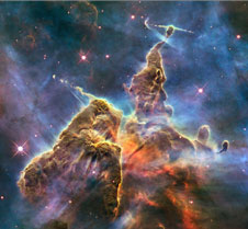 This Hubble photo is of a small portion of one of the largest-seen star-birth regions in the galaxy, the Carina Nebula. Towers of cool hydrogen laced with dust rise from the wall of the nebula. 